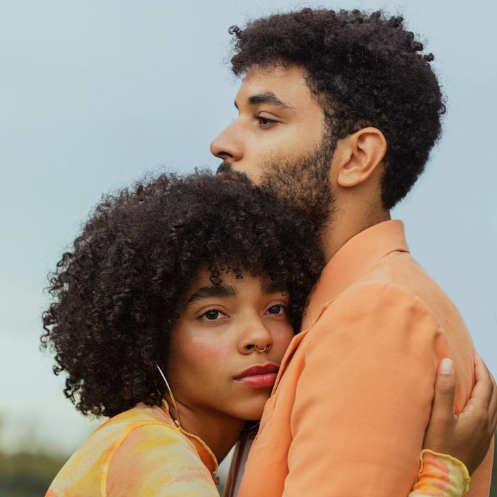 Couple en souffrance Un homme et une femme s'étreignent, visages tournés vers des horizons différents.